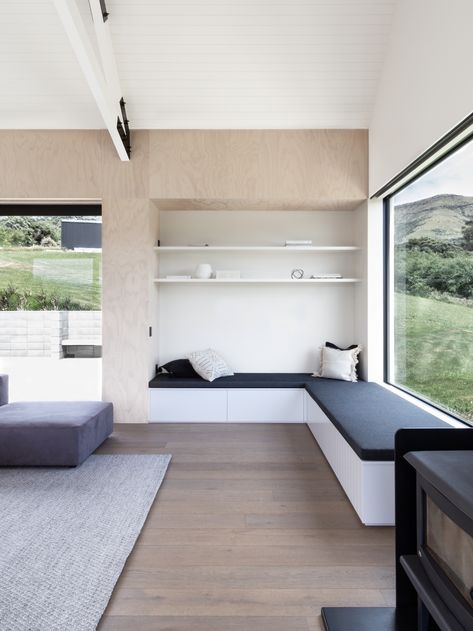 Banks Peninsula House by Lume Design | Gloabl Interiors | est living Steel Frame Doors, Upholstered Bench Seat, Wood Stove Fireplace, Timber Panelling, Lift Design, Barn Style House, Built In Bench, Timber Flooring, Minimalist Kitchen