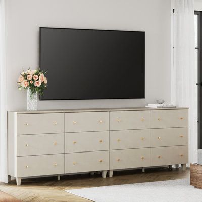 This 12-drawer TV dresser goes well with your bedroom, living room, or anywhere needs to be organized and stored. Each cabinet is equipped with an anti-tip kit which makes it perfect for households with children. Color: Beige | Wade Logan® Bonis TV Stand for TVs up to 88" Wood in Brown | 32.4 H x 94.4 W x 15.3 D in | Wayfair Tv Stand Dresser Bedroom, Tv Above Dresser Bedroom, Tv On Wall Ideas Bedroom, Large Dresser Bedroom, Dresser Under Tv, Tv Stand Dresser, Tv Dresser, Shelves Around Tv, Dresser Decor Bedroom