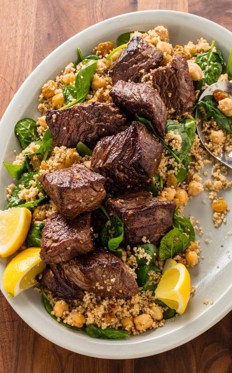 Moroccan Steak Tips and Couscous: Our Moroccan Steak Tips and Couscous recipe is the perfect weeknight one-pan meal that is anything but boring. Warm spices like cinnamon and cumin liven up quick-cooking sirloin while chickpeas, couscous, and spinach complete the meal. Moroccan Beef, Steak Tips, Dish Ideas, Couscous Recipes, America's Test Kitchen Recipes, America's Test Kitchen, Moroccan Food, Fool Proof Recipes, Americas Test Kitchen