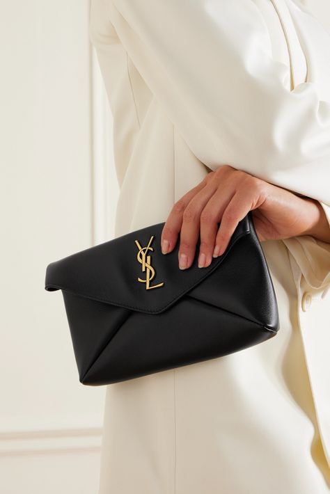 SAINT LAURENT's 'Cassandre' clutch is designed in a classic envelope shape that will never date and is perfectly sized to house all your most-used essentials. It's been made in Italy from black leather and punctuated with a gold-tone 'YSL' logo. Stow your cards and loose keys in the internal slip pocket. Black Clutch Aesthetic, Black Clutch Outfit, Luxury Evening Clutch, Clutch Purse Outfit, Ysl Clutch Outfit, Black Designer Bags, Clutch Outfit, Saint Laurent Clutch, Black Clutch Purse