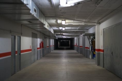 Corridor of underground storage warehouse and parking facility with numbers in each unit Underground Facility Concept Art, Facility Aesthetic, Scp Facility, Weirdcore Gacha, Underground Warehouse, Underground Facility, Underground Storage, Storage Warehouse, Game Level Design