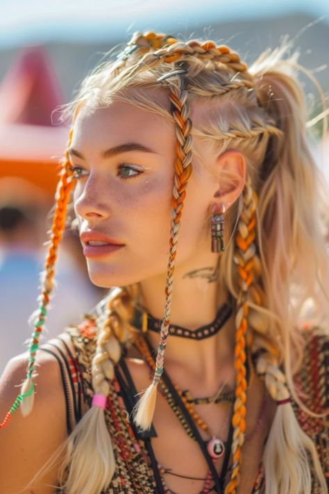 A young woman with intricate orange braids, freckles, and bohemian-style jewelry. Braids Hair Accessories, Colorful Hair Braids, Festival Hairstyles Braids, Braids For Burning Man, Braids With Color Extensions, Coachella Hair And Makeup, Pink Rave Hair, Coachella Hairstyles, Blonde Festival Braids