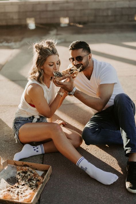 Kristen & Bally having fun with their engagement session while enjoying their favorite pizza. Pizza Date Night Photoshoot, Engagement Photos Funny Creative, Pizza And Beer Photoshoot, Engagement Photos Eating Pizza, Rooftop Valentines Day Photoshoot, Pizza Rooftop Photoshoot, Pizza And Beer Couples Photography, Fun Anniversary Photo Shoot, Pizza Place Photoshoot