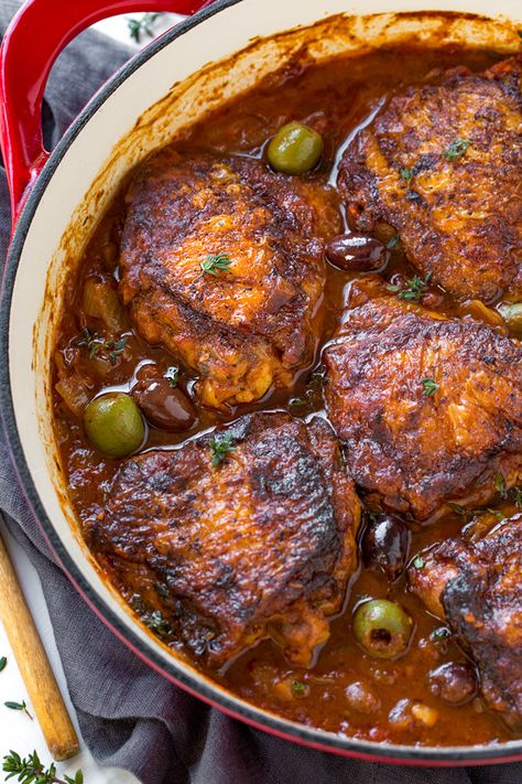 Rustic and saucy, this rich and flavorful braised chicken with tomatoes and olives, plus a tiny hint of white wine, is a simple peasant-style meal finished in the oven to juicy perfection, served with your favorite side. | thecozyapron.com #recipes #dinnerideas #chickenrecipes #braisedchicken Chicken Receipts, Coq Au Vin Recipe, Braised Chicken Thighs, French Recipes, Dutch Oven Recipes, Braised Chicken, Individual Servings, Chicken Dinners, Recipe Chicken