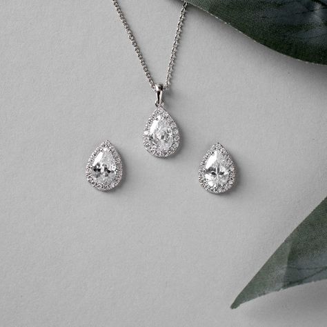 Enhance your bridal attire with this timeless set of a pendant and earrings, embellished with teardrop CZ jewels set in a pave style setting. . #bridetobe2025 #cassandralynnebridal #bridetobe #jewelry #bridal #gettingmarried #bridalaccessories #bridesmaid #bridesmaidgifts #weddinginspo #bridaljewelry Female Necklace, Bridal Pendant, Pear Pendant, Bridal Attire, Bridemaids Gifts, Cz Necklace, Wedding Jewelry Sets, Teardrop Earrings, Bridal Accessories