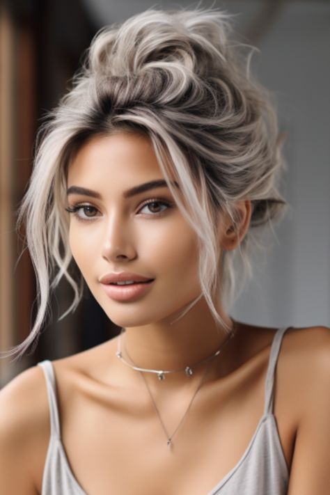 A silver messy bun is a laid-back, chic style perfect for everyday wear. This simple updo lets your silver color shine while offering a casual, effortless vibe. Click here to check out more stunning silver hair color ideas for 2023. Pelo Bob Ondulado, Hair Color Ideas For 2023, Silver Hair Color Ideas, Braids Blonde, Silver Blonde Hair, Grey White Hair, Grey Hair Inspiration, Silver Hair Color, Silver Grey Hair