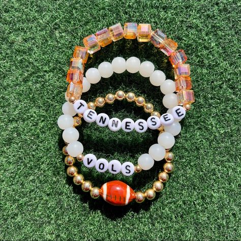 Tennessee Volunteers Game Day Bracelet Stack Celebrate Football Season In Style With This Tennessee Volunteers, Crystal Orange And White Bracelet Stack. Perfect For Game Day! This Listing Is For A Stack Of 3 Bracelets. All Items Are Made To Order And Ship Within 5 Days. Note: All Beads Are Handmade And May Vary In Color And Size From The Listing Picture. Spacer Bead May Vary Depending On Availability And Not Guaranteed To Tarnish. Stack Game, Football Bracelet, Tennessee Vols, White Bracelet, Word Bracelet, White Bracelets, Tennessee Volunteers, Heishi Beads, Football Season