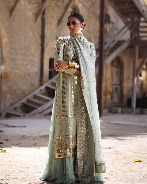 Finely crafted mint green ensemble embellished with meticulous mukesh work. Shirt: Mint green pure mysori heavy kaamdani shirt in gold and silver Bottoms: Mint green pure chiffon layered flowy pants Dupatta: Mint green net dupatta with four side border of heavy mukesh work and scallops of kaamdani work onto the palloos Disclaimer Customization is allowed for size and color (upon availability). Design cannot be changed. For custom orders, please contact our sales team on WhatsApp. #pakis... Iqbal Hussain, Mukesh Work, Silver Bottoms, Pakistan Wedding, Sufi Mystic, Side Border, Fancy Suit, Antique Embroidery, Pure Chiffon