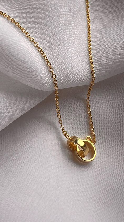 Add a touch of elegance and meaning to your jewelry collection with our 14-carat gold-plated Double Circle Necklace. This stylish and modern piece features two interlocking circles, symbolizing unity, connection, and eternal love. Whether you're celebrating a close friendship, a romantic relationship, or a special bond, this necklace serves as a beautiful reminder of togetherness. Key Features: *High-quality 14-carat gold-plated design *Adjustable chain for a perfect fit (16-18 inches) *Trendy, minimalist style that pairs well with any outfit  Meaning: The interlocking circles represent an unbreakable bond, making this necklace a meaningful gift for loved ones. Whether it's for a friend, a family member, or a partner, the double circles convey unity, trust, and endless connection. It's a s Double Circle Necklace, Interlocking Circle Necklace, Double Rings, Astoria Ny, Trending Necklaces, Rings Necklace, Circle Pendant Necklace, Dope Jewelry, Double Ring