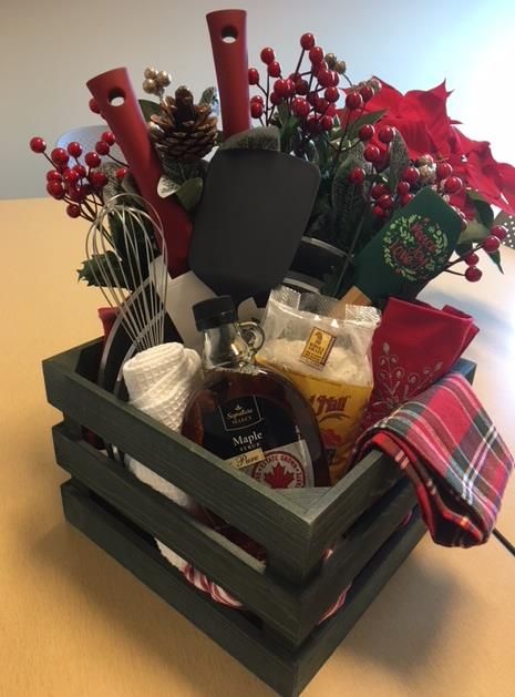 Staff Holiday Basket for the raffle....so cute.  Items purchased at Walmart, Safeway, and Burlington.  Created for just under $100.00.  the picture doesn't show the pans very well but there are 2 nice pans in the basket, pancake mix, maple syrup, about 6 christmas dishtowels, a spatula and a whisk. Could be made less expensive with only 1 pan and less towels and tools. Christmas Raffle Basket Ideas Fundraising, Maple Syrup Gift Basket Ideas, Winter Raffle Basket Ideas, Christmas Raffle Basket Ideas, Jingle Baskets, Jingle Basket, Gift Basket Ideas For Friends, Basket Raffle, Yankee Swap Gift