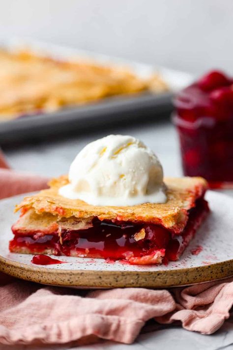 Cherry Slab Pie is an American classic made to serve a crowd! This recipe uses a tender, flaky crust that surrounds sweet, juicy cherry pie filling. It tastes incredibly delicious and is the perfect dessert for any time of year. Cherry Slab Pie Recipe, Cherry Slab Pie, Triple Berry Pie, Slab Pie Recipes, Apple Slab Pie, Perfect Apple Pie, Canning Cherry Pie Filling, Slab Pie, Holiday Baking Recipes