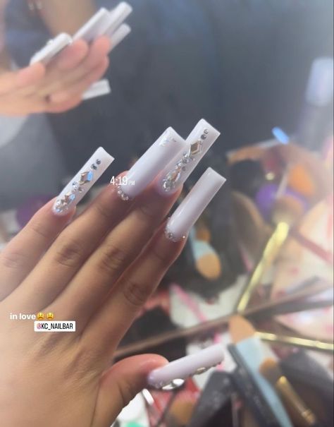 Long Tapered Square Nails White, White Acrylic Nails Diamonds, Nails W Rhinestones Simple, Simple Long Nails With Gems, All White Long Acrylic Nails, White Nails With Designs With Diamonds, V Tip Nails With Rhinestones, Bling White Acrylic Nails, Valentines Day Nails Rinstone