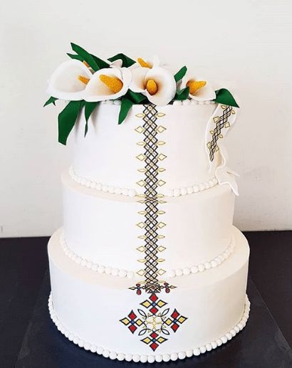 3-tier Habesha Wedding Cake Crowned with White Flowers | Clipkulture | Clipkulture Habesha Wedding Decoration, African Wedding Cakes, African Cake, Habesha Wedding, Zulu Wedding, Igbo Traditional Wedding, Hall Decorations, Traditional Wedding Jewellery, Ethiopian Wedding