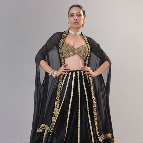 The classic black silk velvet lehenga features a light golden border and a heavy metallic sequins zardozi border. Paired with a full zardozi embroidery sweetheart neck blouse, the set exudes elegance. Completing the ensemble is a black silk Georgette dupatta cum cape, featuring metal sequins and a dabka zardozi border. #BlackVelvetLehenga #ZardoziEmbroidery #SilkGeorgetteDupatta #BridalElegance #RichaAhluwalia #festivewear #bridalcouture #handcraftedclothing #indianwedding #bridesofinstagram ... Zardozi Border, Sweetheart Neck Blouse, Golden Blouse, Velvet Lehenga, Black Lehenga, Zardozi Embroidery, Golden Border, Georgette Dupatta, Bridal Elegance