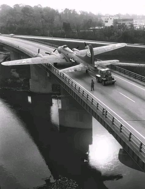 A Boeing B-17 Flying Fortress from the US Air Force Museum collection being moved over the Mad River Bridge, Ohio from Patterson Field to Wright Field, 1957. Boeing B-17 Flying Fortress, B 17 Flying Fortress, B17 Flying Fortress, Military Surplus Store, Flying Fortress, River Bridge, Ww2 Planes, B 17, Military Surplus