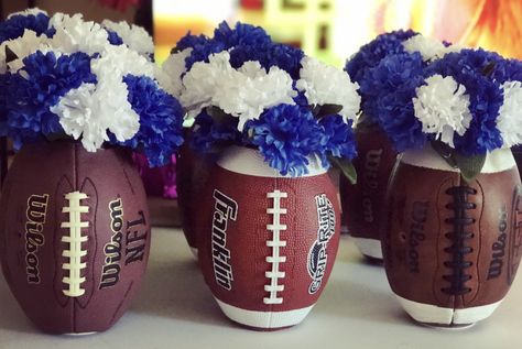 Football vases made from footballs ($4.88 Walmart footballs, or thrift store footballs. The cheaper the material, the better!) and dollar tree vases & flowers! Perfect for super bowl parties, or a football themed wedding! Rugby Centerpiece Ideas, Football Wedding Centerpieces, Football Vase Centerpiece, Dollar Tree Diy Football Decor, Football Flower Arrangements, Football Wedding Shower Theme, Football Themed Wedding Reception, Football Centerpiece Ideas, Football Banquet Ideas