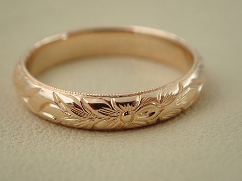 "This half round wedding band can be made in 14k, 18k gold and platinum. Ring is beautify carved with a floral pattern design and millgrained, and high polish all round on all sides. The band is approximately 3.5 mm wide and the thickness is 1.75mm. We can make it any size from 5 to 7 and you still be able to return it within the listed time frame. Sizing outside of that range makes it a FINAL SALE. We love this ring because it represents the way jewelry should be made with craftsmanship and qua Carved Gold Ring, Floral Gold Ring, Engraved Gold Wedding Band, Floral Engraved Wedding Band, Vintage Gold Wedding Band, Patterned Wedding Band, Hand Engraved Wedding Band, Floral Wedding Band, Engraved Wedding Band