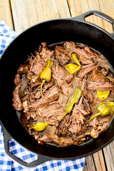 A chuck roast in a black dutch oven with peppers. Chuck Roast In Dutch Oven Recipe, Pot Roast Cast Iron Dutch Oven, Mississippi Pot Roast In Dutch Oven, Mississippi Pot Roast Dutch Oven, Dutch Oven Mississippi Pot Roast, Dutch Oven Stuffed Peppers, Pepperchini Roast, Chuck Roast Recipes Dutch Oven, Chuck Roast In Dutch Oven