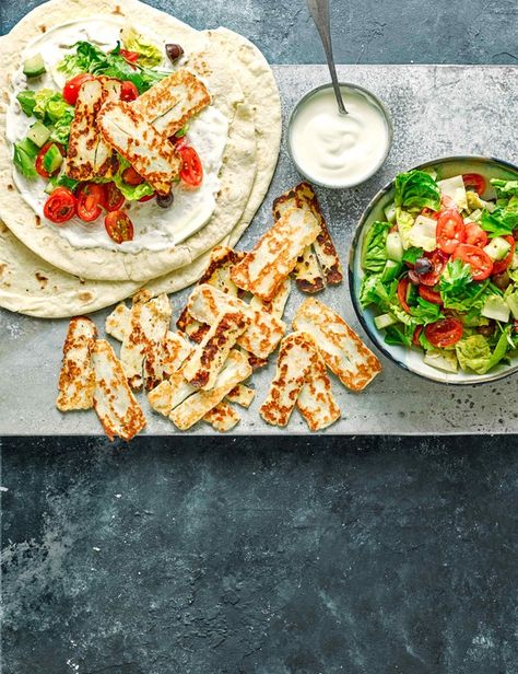 Salty halloumi makes a satisfying vegetarian wrap filling. Serve with a fresh and bright salad for a quick, nutritious midweek meal Greek Salad Wrap, Cooking Halloumi, Wrap Fillings, Vegetarian Wraps, Healthy Lunches For Work, Salad Wraps, Midweek Meals, Greek Salad, Wrap Recipes