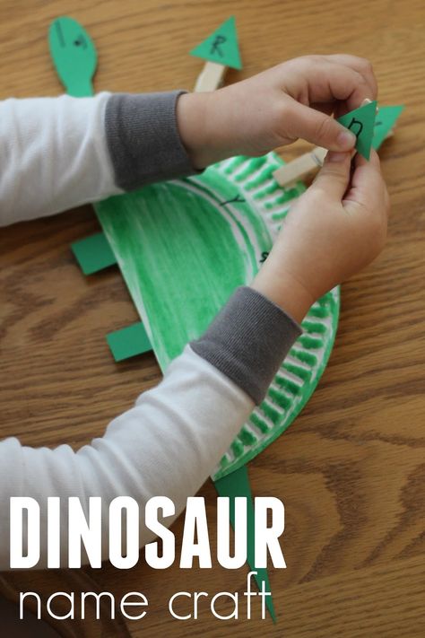 Toddler Approved!: Paper Plate Dinosaur Name Craft Dinosaur Name Craft, Paper Plate Dinosaur Craft, Shape Games For Kids, Paper Plate Dinosaur, Dinosaur Crafts Preschool, Dino Craft, Dinosaur Lesson, Dinosaur Theme Preschool, Dinosaur Craft