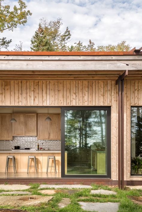 Photo 9 of 27 in Just Getting to the Front Door of This Family’s Midcoast Maine Retreat Is an Adventure - Dwell Granite Pavers, Midcoast Maine, Kitchen Concrete, Outdoor Gathering Space, Concrete Counter, Drop In Sink, Natural Granite, Wood Cabinet, Gathering Space