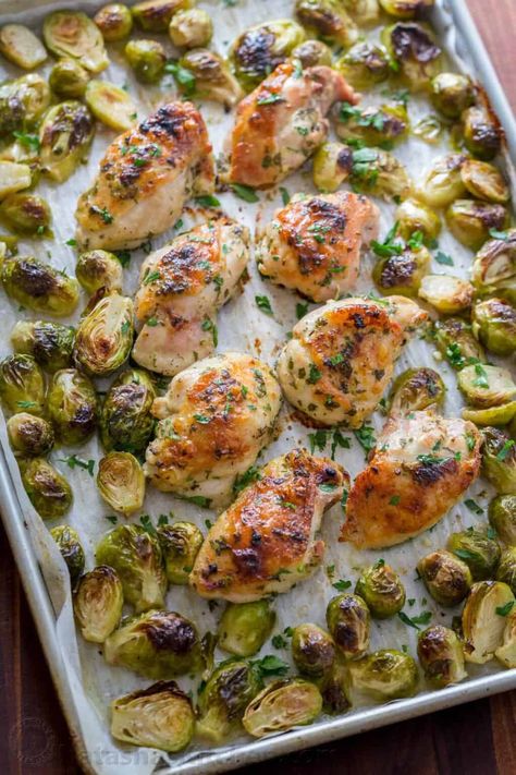 Winner winner chicken dinner! Baked Chicken thighs with a flavorful garlic, lemon and dijon marinade with brussel sprouts that baste in the scrumptious pan drippings. We just love this easy sheet pan chicken and brussels sprouts recipe! Learn our secrets to marinating chicken and how to trim brussel sprouts. | natashaskitchen.com Roasted Boneless Chicken Thighs, Chicken And Brussels Sprouts, Chicken Brussel Sprouts, Easy Sheet Pan Chicken, Baked Brussel Sprouts, Dijon Chicken, Chicken Crockpot Recipes Easy, Sprouts Recipe, Large Family Meals