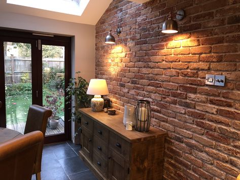 Never used brick slips before, but love the cosy feel they bring to our kitchen! Exposed Brick Wall Lighting, Brick Feature Wall Ideas, Exposed Brick Walls Cottage, Brick Slips Dining Room, Brick Slip Wall Living Rooms, Open Brick Wall Living Room, Brickslips Wall, Brick Feature Wall Dining Room, Slip Brick Wall