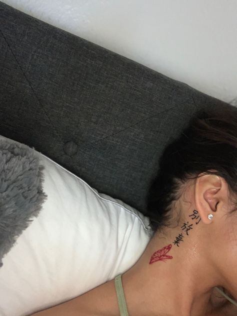 Behind The Ear Chinese Tattoo Ideas, Divine Tattoo Behind Ear, Next To Ear Tattoo, Front Of Ear Tattoos For Women, Behide Ear Tattoo, Chinese Tattoo For Women With Meaning, Red Ink Tattoos On Dark Skin, Red And Black Tattoo Ideas, Never Give Up Tattoo