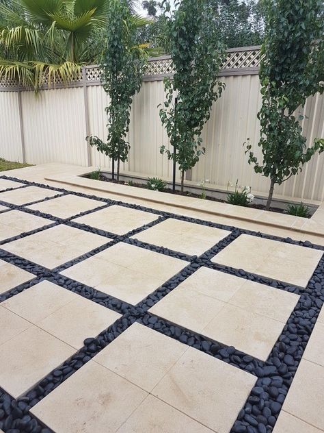 Pavers With Pebbles In Between, Pavers And Pebbles Patio, Patio With Large Pavers, Black Pebbles Landscape, Black Pavers Patio, Modern Pavers Backyard, Black Pebble Landscaping, Pebble Patio Ideas, Garden Pebbles Landscaping