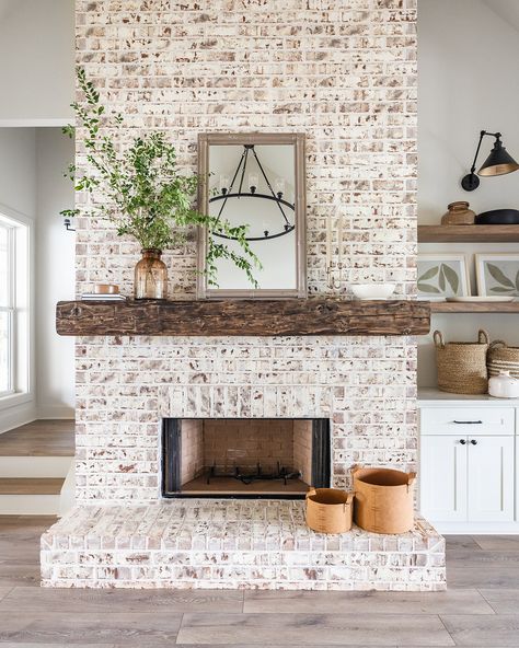 Check out this stunning fireplace design! Our client chose a floor-to-ceiling brick surround, complemented by a beautiful wooden mantel. The built-in cabinetry and floating shelves add both style and functionality, making this the perfect living space! 

Builder: @restorebuildanddesign

Design: @hawkinsandgraydesign

Photos: @lyndseymariephotography White Washing Brick Fireplace, Modern Cottage Fireplace, Gray Built Ins, Wash Brick Fireplace, Whitewashed Brick Fireplace, Brick Fireplace Remodel, Brick Fireplace Ideas, Whitewash Brick, White Wash Brick Fireplace