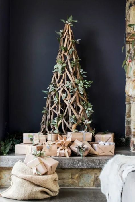 A driftwood Christmas tree from Three Oh Two Willows fits in perfectly with this home’s rustic appeal. Driftwood Tree, Driftwood Christmas, Driftwood Christmas Tree, Minimalist Christmas Decor, Rustic Minimalist, Mele Kalikimaka, Rustic Stone, Stone Cottage, Christmas Décor