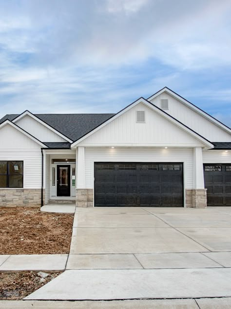 White Black And Stone House Exterior, Neighborhood Home Exterior, White Ranch House Black Windows, New Construction Exterior Ideas, White Siding Black Trim Ranch House, White House With Black Trim Exterior, Exterior Ranch House Colors, White Exterior House With Wood Accents, New Construction Home Ideas Exterior