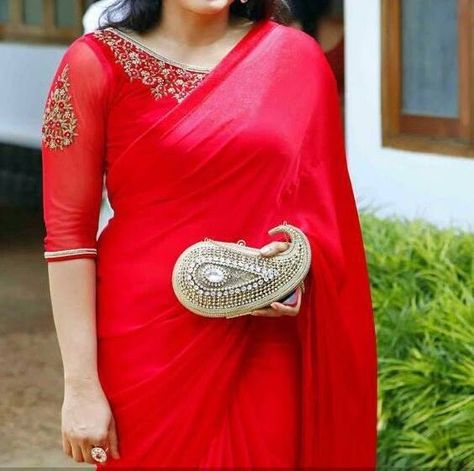 Pretty simple red saree and statement blouse. Love the statement paisley shaped clutch! 3/4 saree blouse. Indian fashion. Simple Red Saree, Net Blouse Designs, Blouse Designs Saree, Netted Blouse Designs, Net Blouse, Blouse Designs Catalogue, Saree Blouse Neck Designs, Net Blouses, Blouse Back Neck Designs