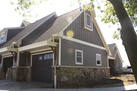 two story farmhouse garage with wooden corbels, stone accents, straight edged shake and vertical Siding Choices, Hardboard Siding, Lp Smartside, Siding Styles, Exterior House Siding, Hardie Board, Hardie Siding, Fiber Cement Siding, Vertical Siding