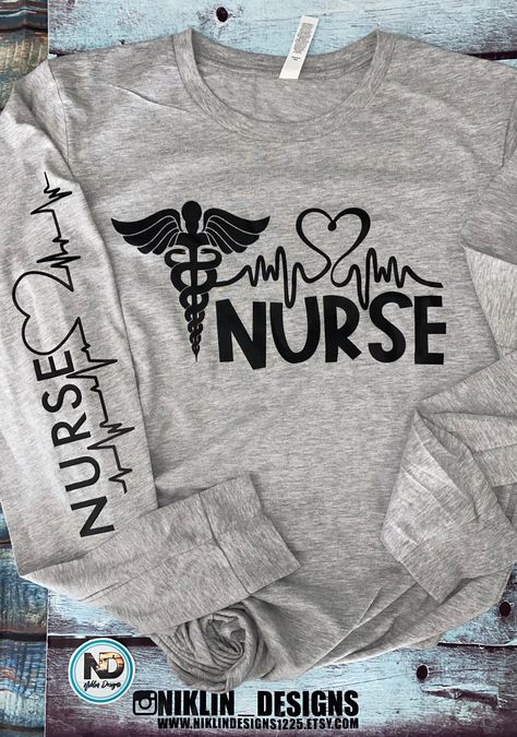 How perfect is this long sleeve lightweight T-shirt that is also soft feel, a great addition to anyone's closet for the Hard working nurse. Great for the in between weather is this shirt. It features the word Nurse on the front in silk screen with the heart and heartbeat and down the sleeve the word nurse with the heart and heartbeat in black vinyl . No way can anyone go wrong with this top.  This is a light heathered grey top pictured. Tear-away label Ribbed cuffs Sideseamed Retail fit Triblends - 3.8 oz., 50% poly, 25% combed ringspun cotton, 25% rayon, 40 singles All other Heather colors are 52% combed and ringspun cotton, 48% polyester Athletic Heather is 90/10 combed ringspun cotton/poly Ash is 99/1 combed ringspun cotton/poly 30 singles 4.2 oz., 100% combed and ringspun cotton All or Nursing T Shirt Ideas, Nurse Shirts Ideas Design, Nurse T Shirts Ideas, Nurse Shirts Vinyl, Nurse Shirts Ideas, Nursing T Shirts, Nurse T Shirts, Nurse Clothing, Shirt Slogans