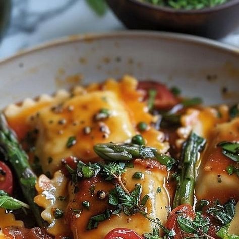 Lizzie Ann Lowery on Instagram: "Sun-Kissed Ravioli with Tomato, Asparagus, and Herbs  Ingredients:  1 package of fresh cheese ravioli 2 cups cherry tomatoes, halved 1 bunch asparagus, trimmed and cut into 1-inch pieces 3 tablespoons olive oil 2 cloves garlic, minced 1/4 cup fresh basil, chopped Salt and pepper to taste Grated Parmesan cheese, for garnish  Instructions :  Bring a large pot of salted water to a boil and cook the ravioli according to the package instructions, usually for about 4-5 minutes, until they float to the surface. Drain and set aside. While the ravioli cooks, heat olive oil in a large skillet over medium heat. Add the garlic and sauté for about 1 minute until fragrant. Add the cherry tomatoes and asparagus to the skillet and sauté for 5-7 minutes until the asparagus Cheese Ravioli With Asparagus, Ravioli With Tomatoes Asparagus Garlic And Herbs, Ravioli With Tomatoes And Asparagus, Ravioli With Tomatoes Asparagus Garlic, Sun Kissed Ravioli With Tomato Asparagus, Ravioli With Garlic Basil Oil, Tomato Herb Ravioli Delight, Asparagus Garlic, Cheese Ravioli