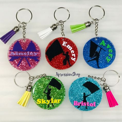 "A handmade personalized glitter Color Guard keychain just for you. Perfect for dance gift bags, majorettes, marching band gifts, backpacks, bag tags etc.  You can pick your choice of color for the glitter, name and flag. If no specification is given for the flag color in the personalization box, I will use black and white for the name if a color is not provided. If you would like the silhouette in a different color than black, please specify the color in the personalization box. Each key chain Gifts For Color Guard Cute Ideas, Color Guard Team Gifts, Colorguard Gifts Ideas, Color Guard Gifts, Diy Graduation Party Decor, Majorette Dance, Marching Band Gift, Band Gifts, Color Guard Flags