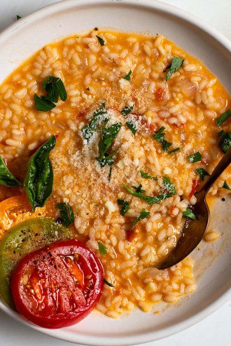 This summery risotto is based on red, ripe tomatoes from the garden, but if you want to up the tomato quotient, surround the finished dish with slices of multicolored heirloom varieties. Best as a first course or vegetarian main course, it could also pair with a main course. Tomato Risotto Recipes, Tomato Rice Soup, Filet Mignon Chorizo, Tomato Risotto, Vegetarian Main Course, Tomato Rice, Meat Dinners, Risotto Recipes, Nyt Cooking