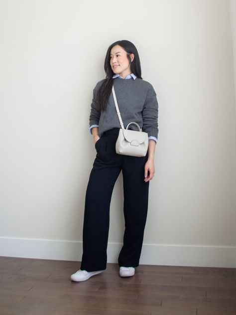 Sharon of Her Simple Sole is showcasing a outfit wearing one of her new Everlane staples, featuring a grey sweater, a blue relaxed button up shirt, black wide-leg pants, an off-white crossbody bag and white sneakers | minimalist outfits | simple outfit ideas White Button Down Shirt Under Sweater, Button Up Shirt Layering, Blue Shirt Outfit Winter, Button Down Sweater Outfits, Casual Wide Leg Pants Outfit, Shirt Under Sweater Outfit, Blue Wide Leg Pants Outfit, Leather Pants Outfit Winter, Shirt Under Sweater