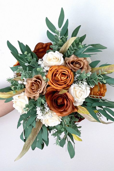 A seasonal bouquet feels elegant for your big day. From my love of weddings, this one elevates a winter-themed wedding. Add this to your bridal floral collection. Simple Winter Floral Arrangements, Rust And White Bridal Bouquet, Green And Orange Bridal Bouquet, Yellow Winter Wedding Bouquet, White And Green Winter Bouquet, Red Bridal Bouquet Winter, Wedding Floral Bouquet, Winter Floral Arrangements, Snowy Wedding