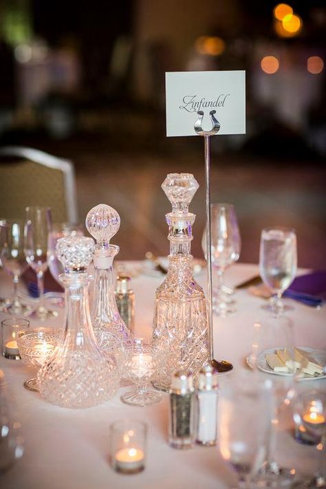 Pretty crystal bottles add a romantic, timeless touch to wedding decor. Have a coordinated day. {Photography by Sonia Savio} #wedding #weddingplanner #weddingdesign #designer #crystal #bride #love Glass Crystal Decor, Decanter Centerpiece, Decanter Ideas, Vintage Bottles Decor, Decanter Display, Wine Themed Wedding, Wedding Centerpeices, Gentlemen Club, Wedding Table Setup