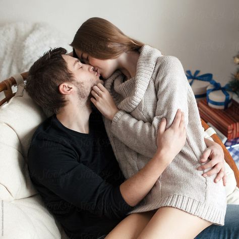 Handsome man kiss his girlfriend in warm sweater Couple Morning Beds Aesthetic, Sitting In Lap Cuddles, Couple Cuddles Sofa, Siting In Lap Couple, Sitting Hug Couple, Sit Lap Couple, Hugs Sitting On Lap Couples, Couple Poses Sitting On Lap, Cuddling On Sofa Pose