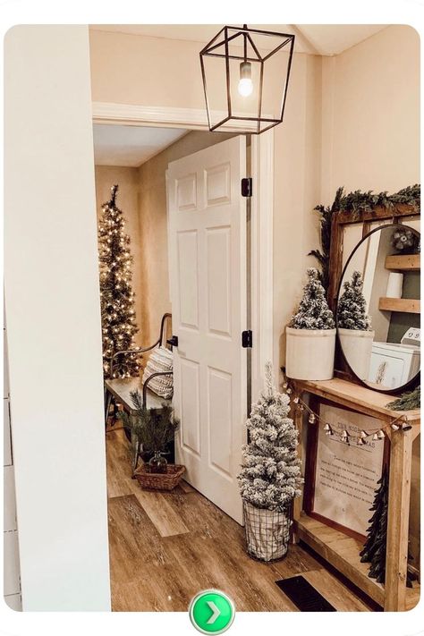 Green-themed holiday decor with small trees creates a vibrant, natural feel. The mirror enhances light, giving the entryway a lively and elegant holiday atmosphere. Elegant Christmas Decor Ideas, Entryway Christmas Decor, Entryway Christmas, Elegant Entryway, Elegant Christmas Decor, Small Entryway, Elegant Christmas, Christmas Decor Ideas, Small Trees