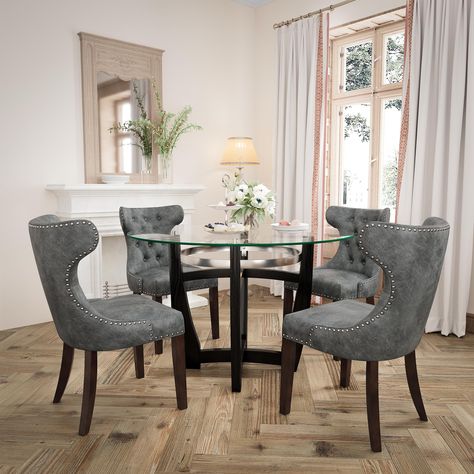 PRICES MAY VARY. Chic Glass Dining Table Chair Set: Full of modern charm, PADMA HOUSE Dining Table made of solid wood leg base and tempered glasstop, making a stylish statement. The wingback dining chairs built with wood legs and PU leather finish plus nailhead trim are sure to add a touch of elegance to your home. Easy to Storage and Keep Tidy: The chairs can be moved under the dining table when you finish your meal, and our kitchen table set largely helps you save room space. Featuring smooth Dining Room Glam, Glam Dining Room, Wingback Dining Chair, Kitchen Table Set, Round Kitchen Table, Dining Table Chair, Leather Dining Room Chairs, Round Kitchen, Modern Dining Room Tables