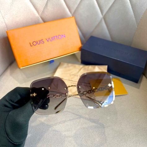 The Oversized Square Shape Of This Season's Lv Jewel Square Sunglasses Makes Them A Standout Style. This Iteration Is Balanced By Rimless And Faceted Lenses And Includes Refined Details Such As A Slender Signature Chain On The Temples. House Signatures Include Lv Initials And Monogram Flowers, Which Are Embedded Into The Design Of The Chain. Gold-Toned Hardware Frame Gradient Blue/Orange Lenses Square Shape Chain Signature On Temples Monogram Flowers On Nose Pads Monogram Flower Studs On Lenses Lv Sunglasses Women, Louis Vuitton Evidence Sunglasses, Lv Sunglasses, Sunglasses Aesthetic, Sunglasses Box, Louis Vuitton Sunglasses, Stylish Glasses, Louis Vuitton Accessories, Rectangular Sunglasses