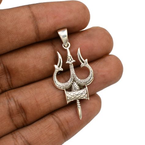 BIG ANNOUNCEMENT - FREE 925 STERLING SILVER CHAIN ON PURCHASE OF $100 AND ABOVE LORD SHIVA TRIDENT PENDANT This Dainty Lord Shiva Trident Pendant is perfect for daily wear. It comes with a 925 silver stamp for authenticity. This minimalist pendant can be CUSTOMIZED as per your requirements. This silver pendant goes well with every outfit and occasion. It's a perfect gift for Mom, Girlfriend, Wife, Husband, Father, Brother, Grandma, Sister, Fiancee, Daughter and even your Friends. Special Gift for Mother's Day, Valentine's Day, Easter, Christmas, New Year, Women's Day, Birthdays, Anniversary, Engagement, Bridesmaids, Thanksgiving & Wedding. WE ACCEPT CUSTOMIZATION. CONTACT US FOR CUSTOM ORDERS. FEATURES: Metal: Sterling Silver Metal Purity: 925 Gross Weight: 4.68 gm Approx. Pendant Length: Silver Symbolic Jewelry For Celebrations, Silver Jewelry For Festive New Year, Shiv Jewellery, Trishul Pendant, Trident Pendant, Shiva Trident, Hindu Jewelry, Minimalist Pendant, Silver Chains