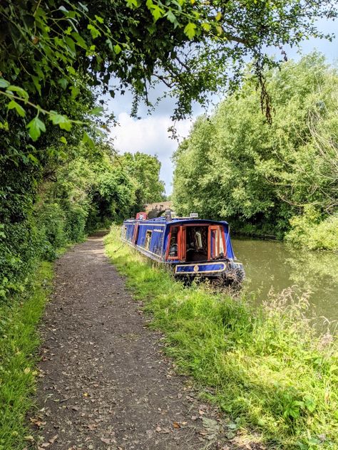 Blue narrowboat moored on a quiet towpath surrounded by trees Canal Aesthetic, Houseboat Living, Uk Weather, Holiday Storage, Packing Guide, Boat Life, Holiday Packing, Boat House, Canal Boat