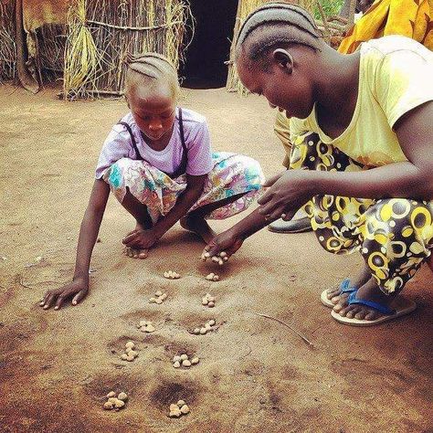 Mancala, a traditional game in many countries on theAfrican continent. Maths Portfolio, Old School Pictures, African Theme, Visit Africa, Cultural Beliefs, South Sudan, African Children, Childhood Games, Camp Life