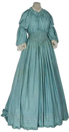 ~A pongee silk dress by Liberty & Co., circa 1895. Liberty was the leading clothing designer of the Aesthetic movement, which advocated simpler, less restrictive dress for women. Although most ladies who embraced it did still wear corsets, it didn't call for tight-lacing as did mainstream fashions of the day. Some adopted the style full-time, but the Aesthetic movement's influence is most commonly seen in tea dresses, for which the relaxed silhouette became the norm~ 1890s Fashion, Tea Gown, Aesthetic Dress, 19th Century Fashion, Period Outfit, Victorian Clothing, Vintage Gowns, Antique Clothing, Edwardian Fashion