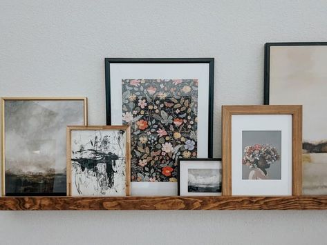 How to Style a Picture Ledge – Love & Renovations Frames On Shelf Display, Photo Shelf Styling, Gallery Wall On Shelf, Shelves With Large Pictures, Picture Shelf Over Sofa, Picture Ledge Above Mirror, Styling Picture Ledges Living Room, Eclectic Picture Ledge, Long Ledge Shelf